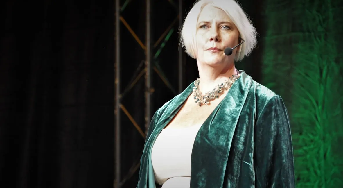 Joanne Flinn keynote speaker on stage at Tony Robbins Wealth Mastery — long-term value, transition risk, and transformation